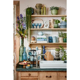 Groene glazen flesvaas in keuken