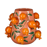 Gekleurde vaas met fruit eraan