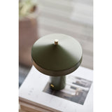 Groene design lamp op boeken